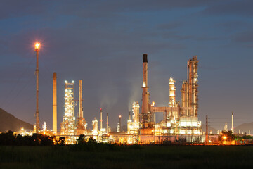 Oil gas refinery plant or petrochemical plant at night. Include gas flare or flare stack. Many machine equipment and pipeline to processing for petrol, petroleum, gasoline or fuel production.