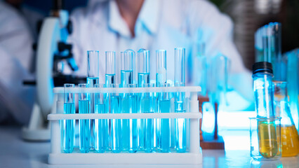 A group of young scientists are conducting experiments in the lab using a microscope., Aspiring scientists are busy running laboratory experiments