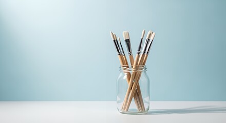 Painting Brushes in Glass Jar on Table