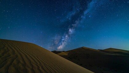 Night sky over desert dunes