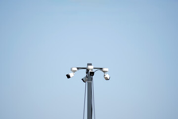 Cameras watch. Steel stands. Sky clears. Silence stays.