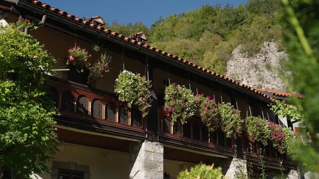 Capturing of architecture of Moraca monastery with blurred green leaves in foreground in Montenegro.