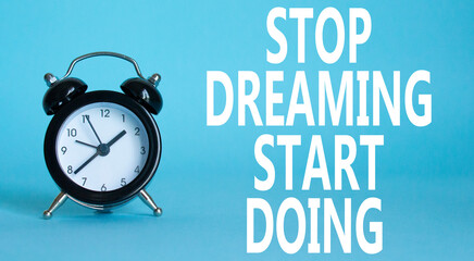 Stop Dreaming Start Doing symbol. Beautiful blue background with alarm clock. Business and Stop...