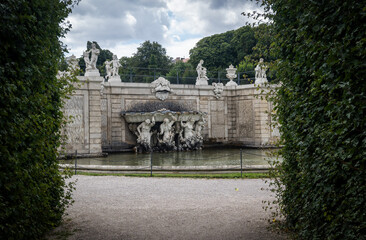 Photo of a small pond with beautiful sculptures at the yard of the Belvedere palace in Austria. .Travel concept	