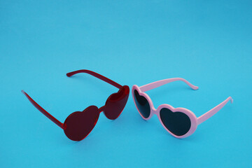 Two sunglasses on a blue background.