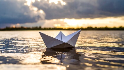 Obraz premium Serene voyage of a paper boat symbolizing dreams and imagination on calm waters at sunset