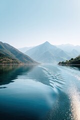 Naklejka premium Calm lake, mountain reflection, serene morning, boat wake. Travel brochure