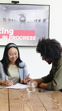 Vertical video: Chinese business partners reviewing contract then signing document and sealing deal