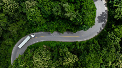 Aerial view semi truck trailer cargo on mountain curve road, Semi truck trailer cargo business...