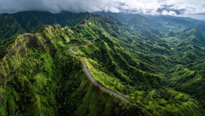 Naklejka premium Winding road through lush green mountain range