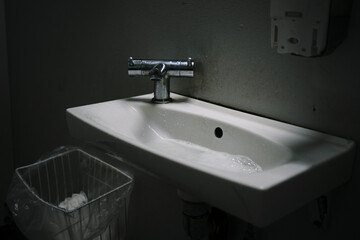 faucet in a dark bathroom