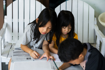 Children sitting around table, having discussion at home