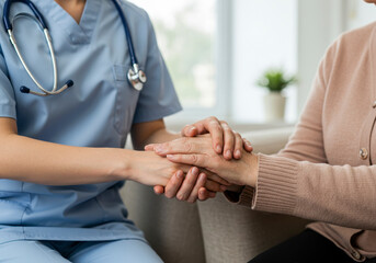 Fototapeta premium Compassionate Caregiver Offers Comfort and Support to Elderly Patient Holding Hands