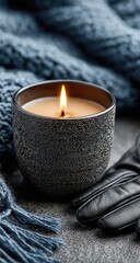 Cozy winter candle with a knit blanket and leather gloves