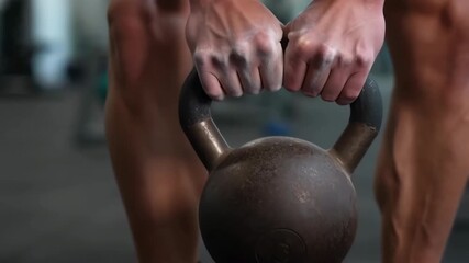 Athlete lifting kettlebell in fitness center - Powered by Adobe