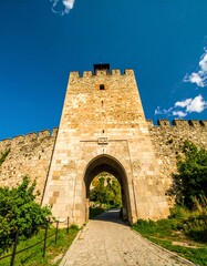 Fototapeta premium Ancient stone gatehouse and city wall