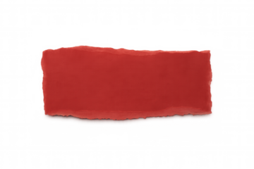 Red torn paper fragment lying on transparent surface, adding vibrant graphic element to creative compositions