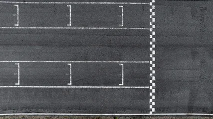 Gordijnen Formule 1 Start and Finish motor race line asphalt on grand prix street circuit, Checkered line on racing motorsport race track, Auto or automobile background concept.  © Kalyakan