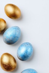 Gold and blue Easter eggs arranged in a curved line against a white background