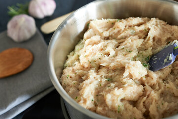 Bowl with minced meat on the table, close-up. Minced chicken. Dietary meat.