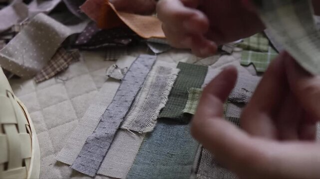 Hand stitching assorted small fabric patches together