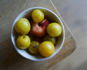 fruit in a bowl on a wooden table