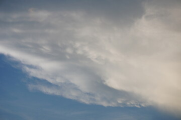 A cloudscape featuring white clouds against a blue sky