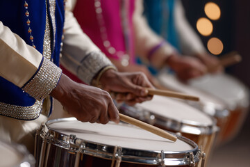 Obraz premium Baraat band with colorful instruments and festive lights, close-up of drummers hands, 