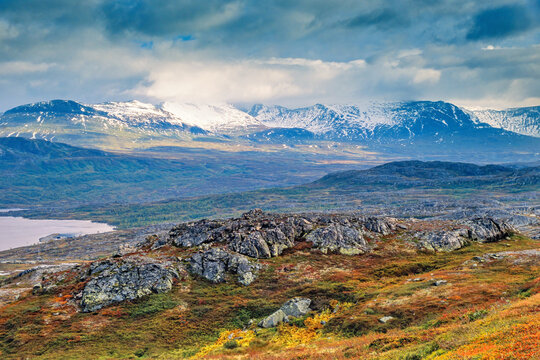 Scenic mountainous landscape view with storm clouds and autumn colours