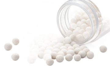 Spilled jar of white ceramic filter media balls