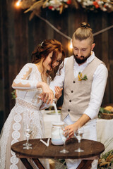 sand ceremony of newlyweds in the creation of a family candle