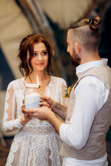 sand ceremony of newlyweds in the creation of a family candle