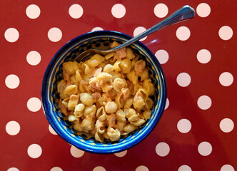 serving of macaroni, cheese and ham on a polka dot place mat