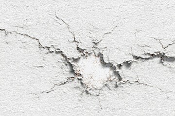 Obraz premium Cracked, weathered white wall with a central hole
