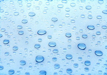 Numerous clear water droplets scattered across a light blue surface, creating a textured pattern isolated on transparent background