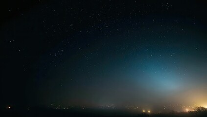 Starry night sky, hazy horizon with lights