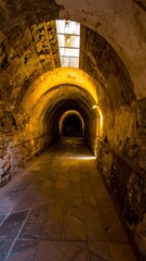 Fototapeta premium Ancient tunnel, sunlight filtering through