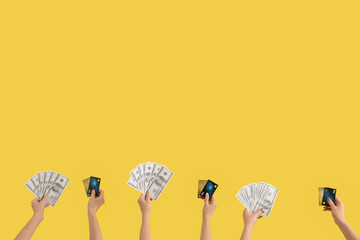 Women with credit cards and dollar banknotes on yellow background