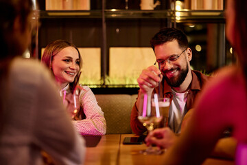 Group of Friends Enjoying Drinks and Laughing at a Cozy Restaurant