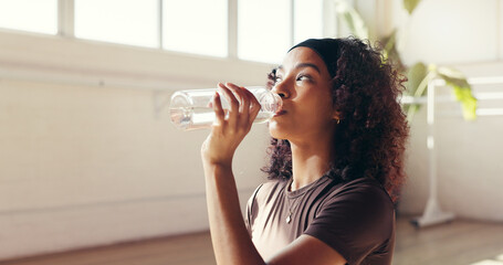 Woman, fitness or drinking with water for hydration, recovery or natural beverage in gym. Female person, yogi or thirst with aqua, mineral liquid or bottle for workout break or rest in health club