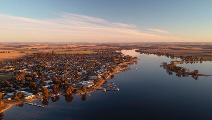 Aerial view of town by lake at sunrise