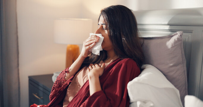 Tissue, cough and woman in bed in home with cold, flu or illness with recovery on weekend morning. Sick, chest pain and female person in bedroom with asthma, lung infection or virus in house.