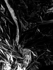 Transparent cellophane bag against a sleek black background, showcasing its glossy, delicate...