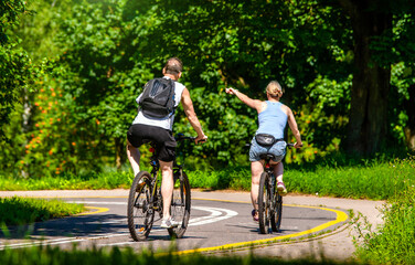 Cyclists ride on the bike path in the city Park
