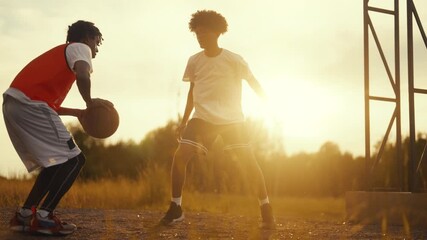 Streetball match, african american boys playing together, brothers or friends. Active sport and leisure, teenagers having fun and training, future champions of basketball league, cinematic slow motion