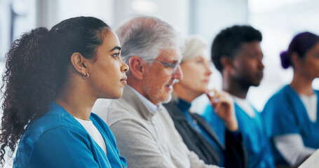 People, meeting and listening with medical team in seminar for presentation, workshop or conference. Group, employees or healthcare workers in row or line for staff training or development in clinic