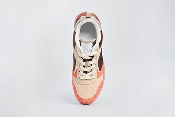 Brown women's suede leather sneaker isolated on white background. Standing sports left shoe, tennis boot.
Footwear, casual leather gym, fitness shoe. Template, mock up, close up, flat lay, view above