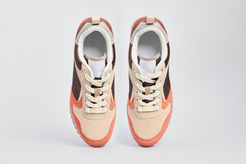 Brown women's suede leather sneakers isolated on white background. Standing sports shoes, tennis boots.
Footwear, casual leather gym, fitness shoes. Template, mock up, close up, flat lay, view above