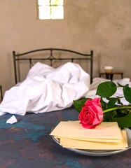 Romantic bedroom scene with rose and letters