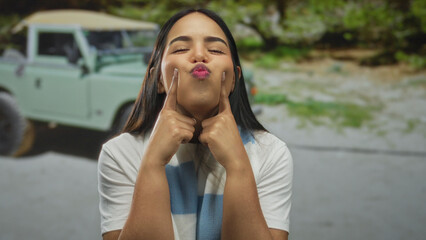 Woman smiling playfully outdoors with an off-road vehicle in the background representing joy and adventure. © Krakenimages.com